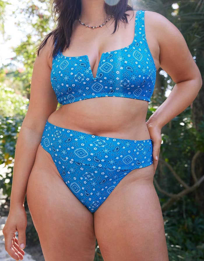 A model in the blue two piece swimsuit