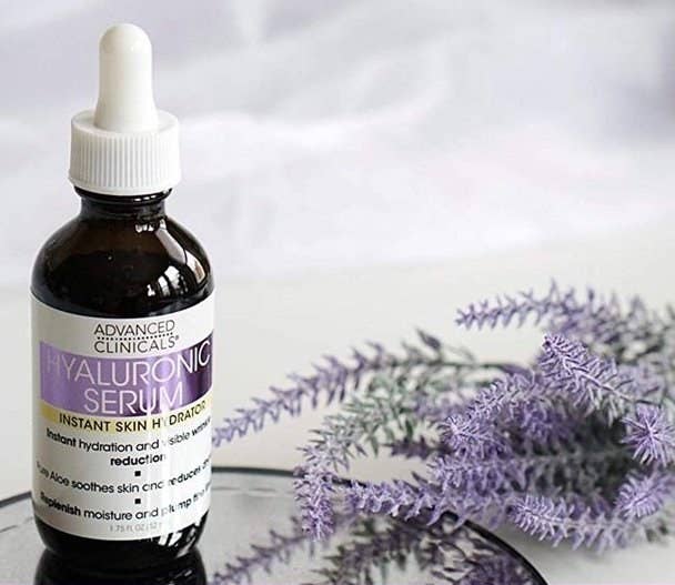 A bottle of hyaluronic acid and lavender stems