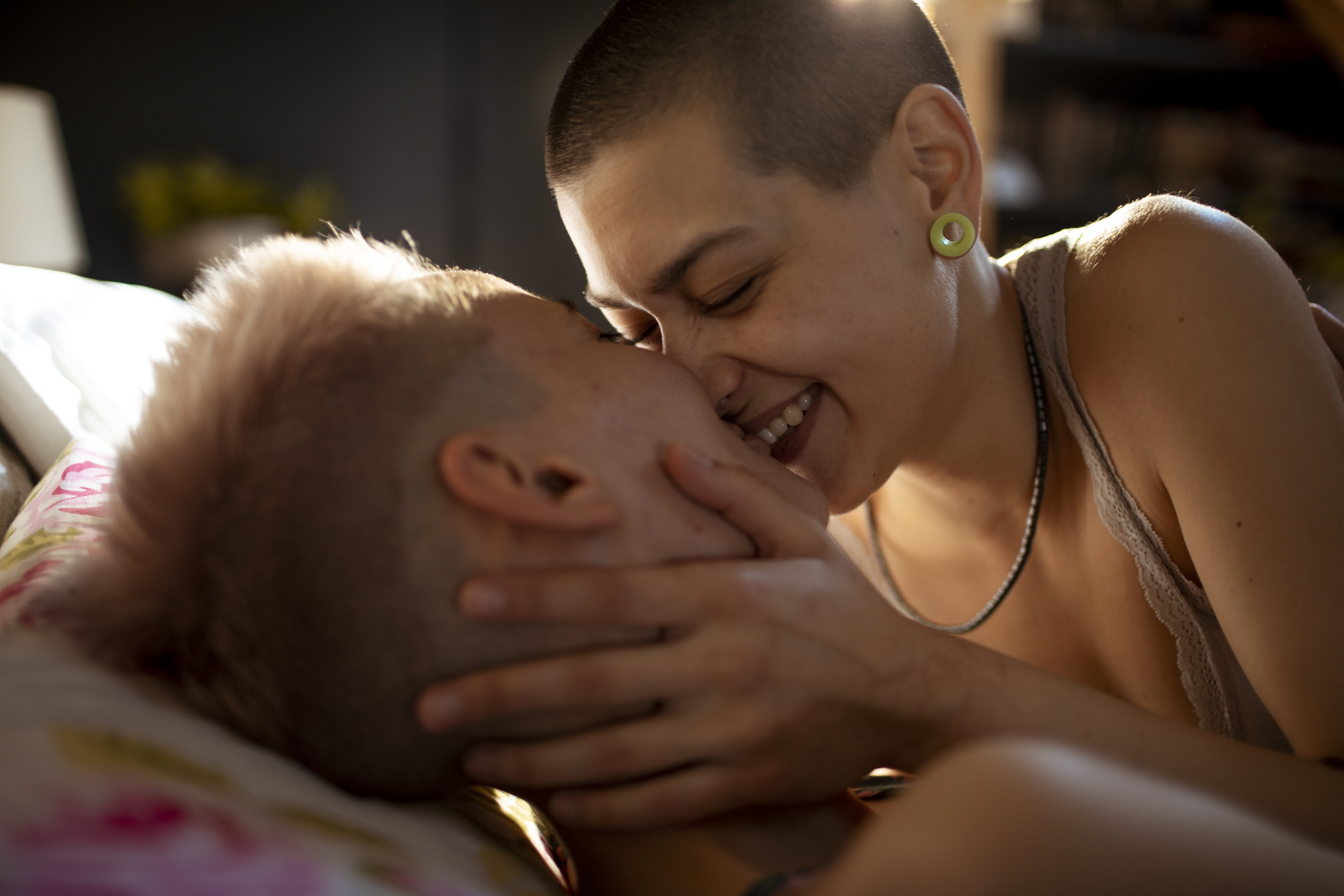 A couple kissing in bed