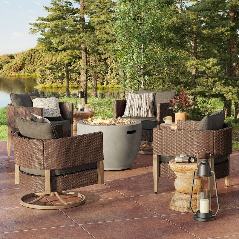 the fire pit with four patio chairs surrounding it