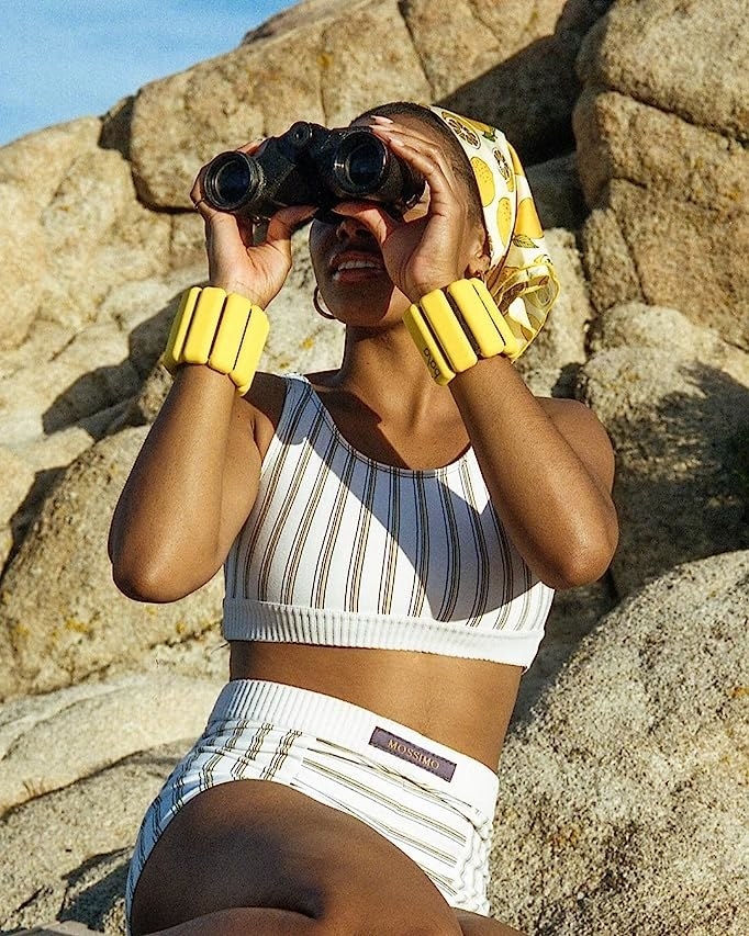 model wearing yellow weights around their wrists
