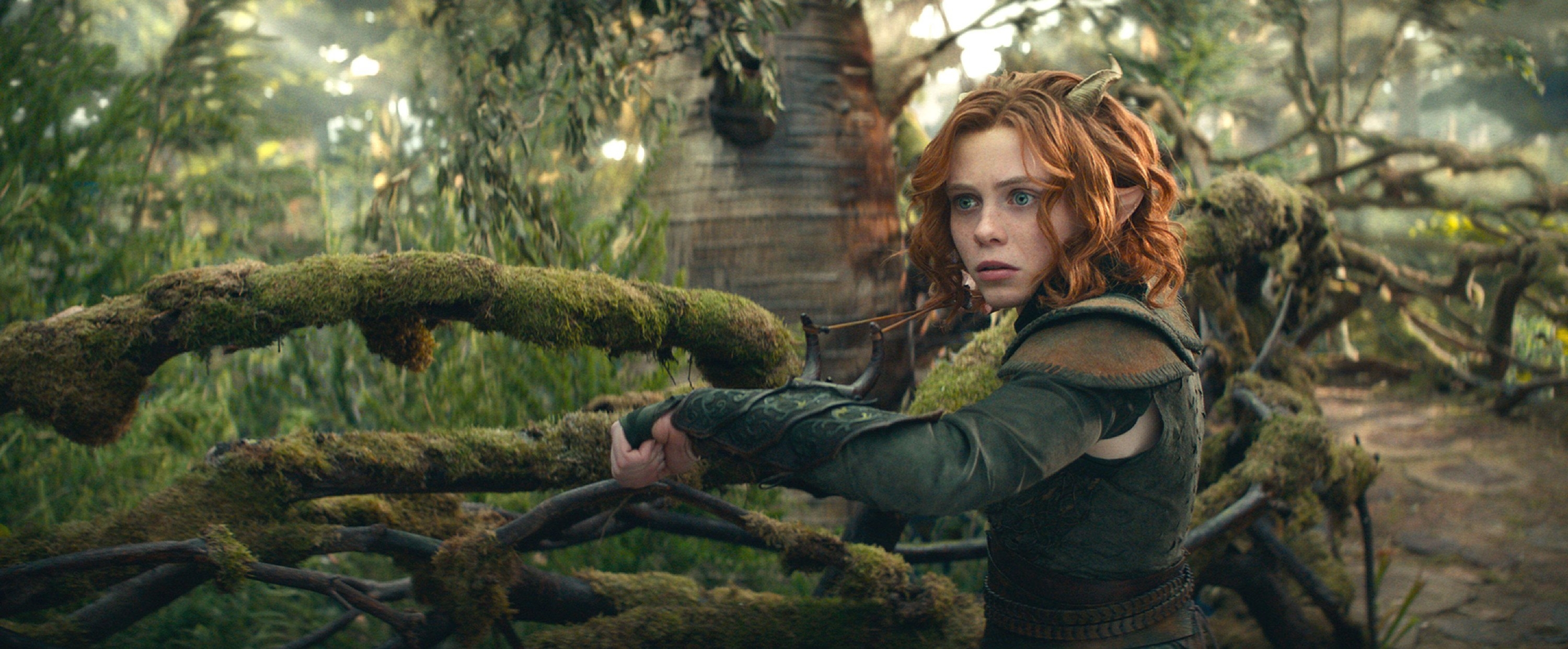 Sophia Lillis stands near a mossy branch in a druid&#x27;s tree home