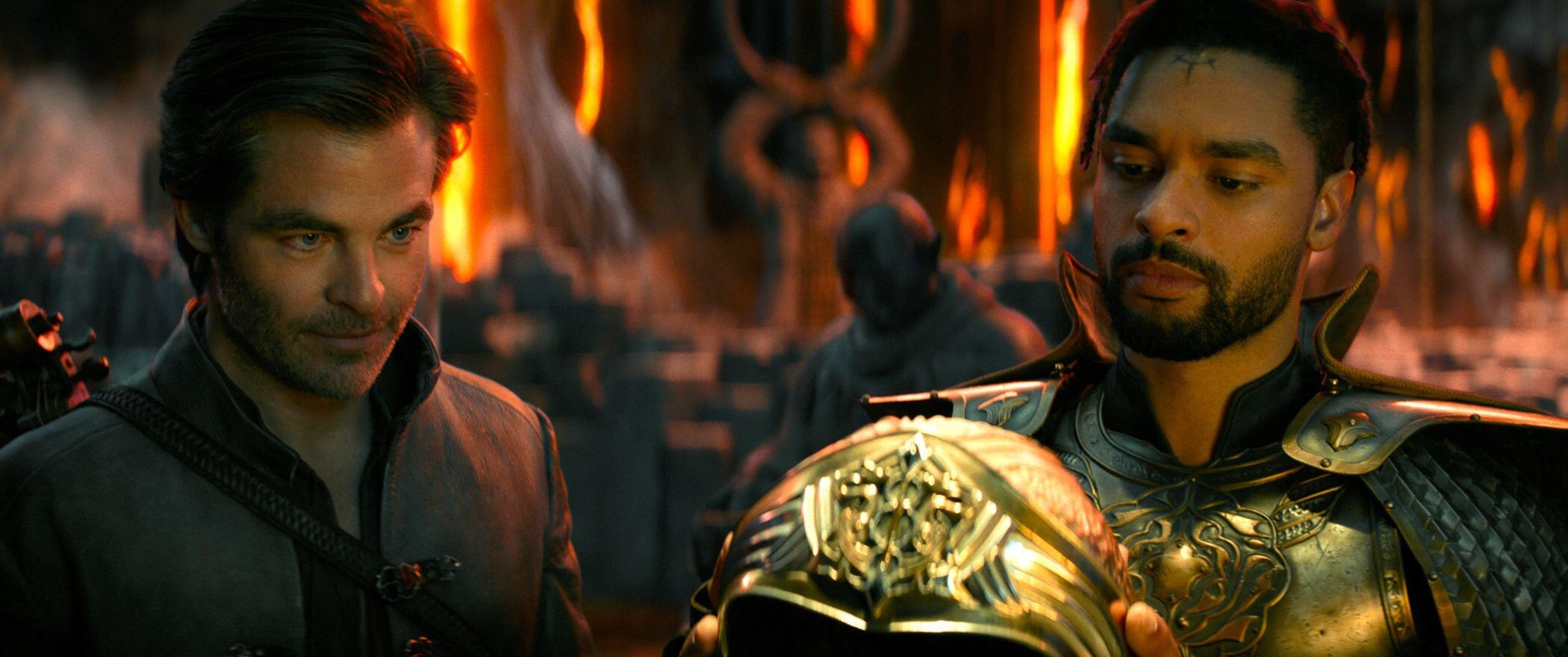 Chris Pine and Regé-Jean Page observe a mythical gold helmet
