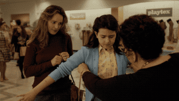 A salesperson measures Margaret for a bra