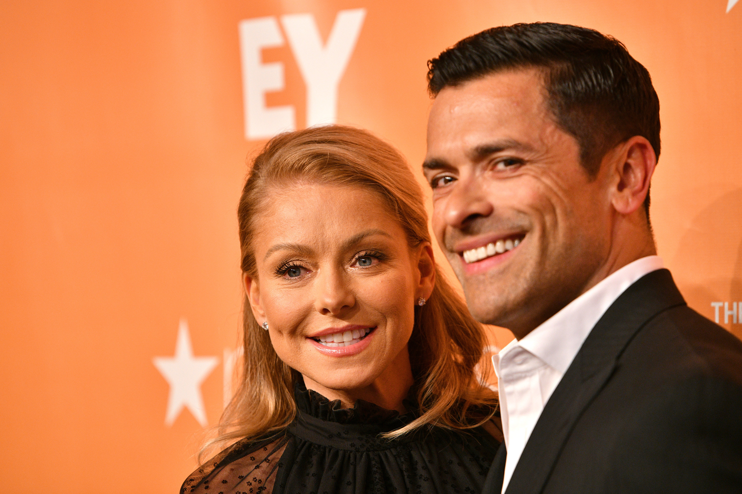 Kelly Ripa and Mark Conseuolos pose in formal wear at an event