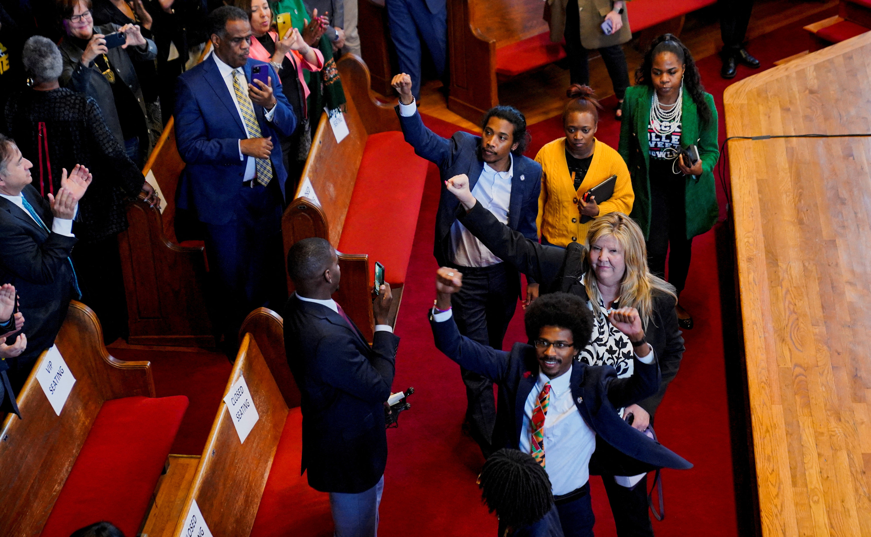 Representatives Gloria Johnson, Justin Jones, and Justin Pearson raise their fists.