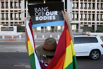 A man protests LGBTQ rights outside of a courthouse