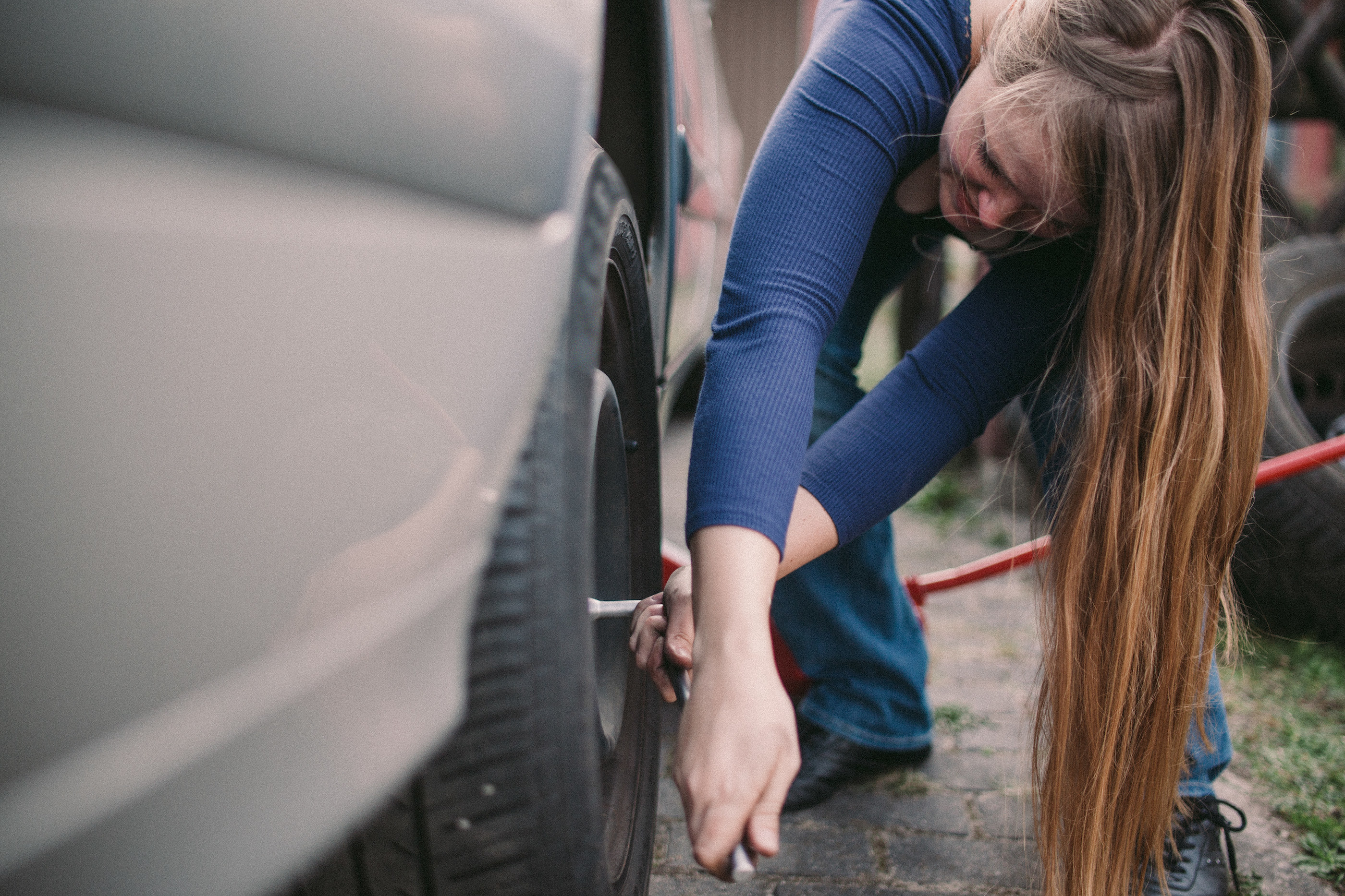 A woman changing her tire