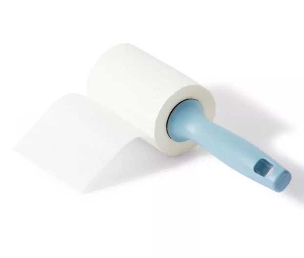 The lint roller with a sheet ready to be used