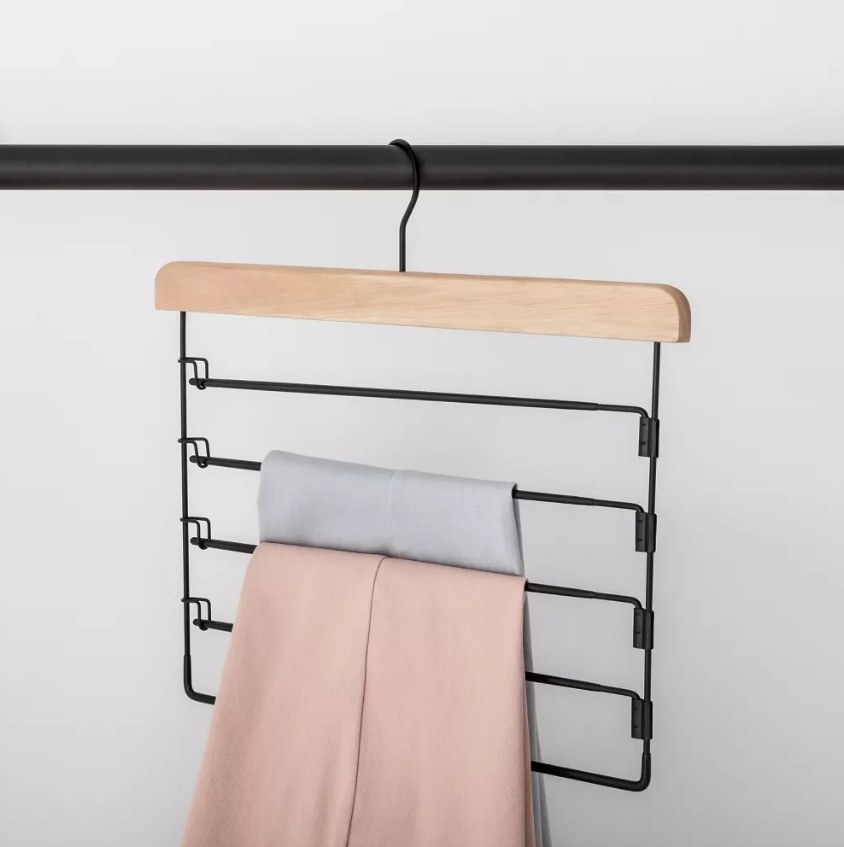 The tiered pants hanger with two pairs of pants on it