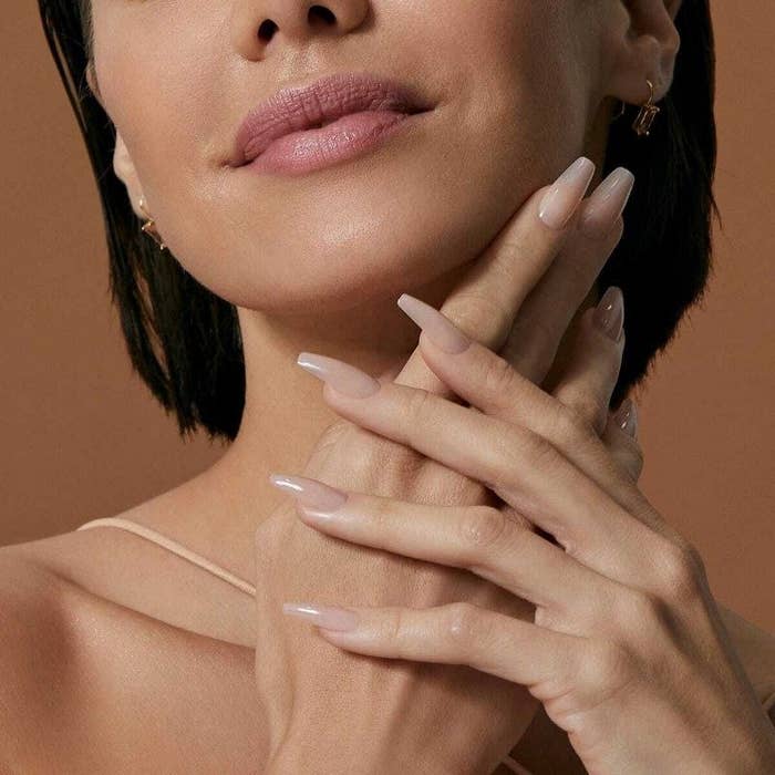 A person with short hair donning a set of nude nails