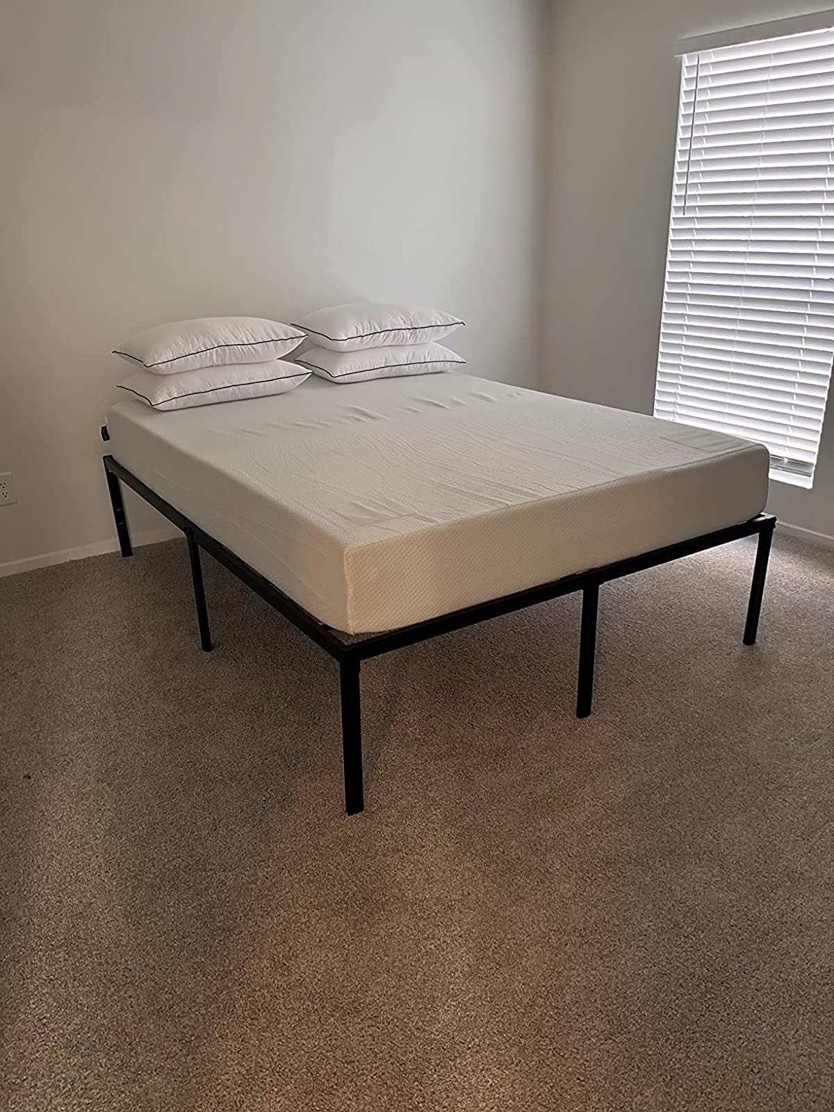 Reviewer's mattress on metal bed frame