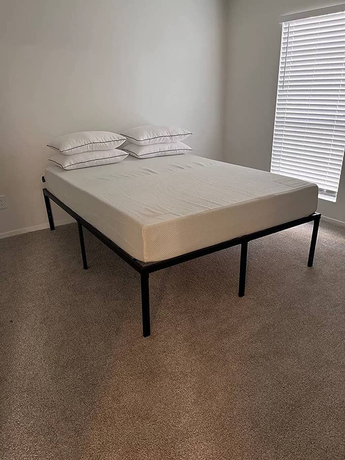 Reviewer&#x27;s mattress on metal bed frame