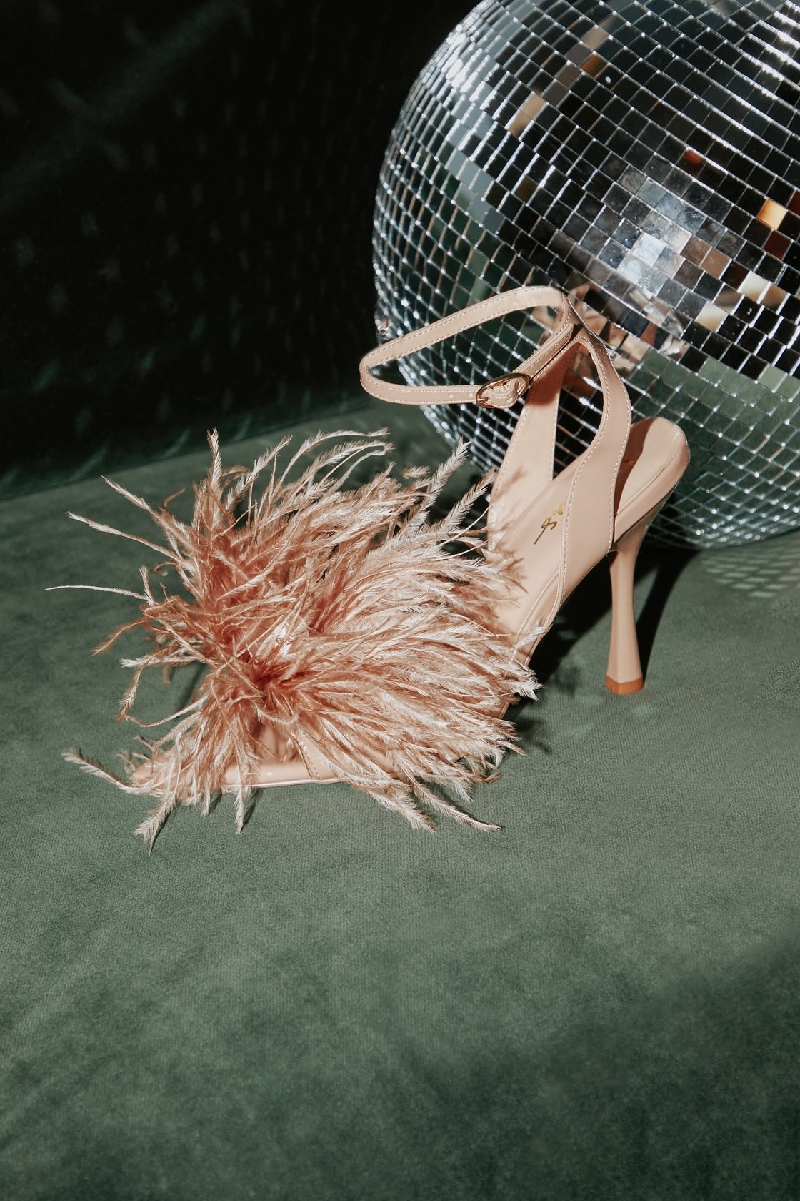 A pair of pink heels with feathers
