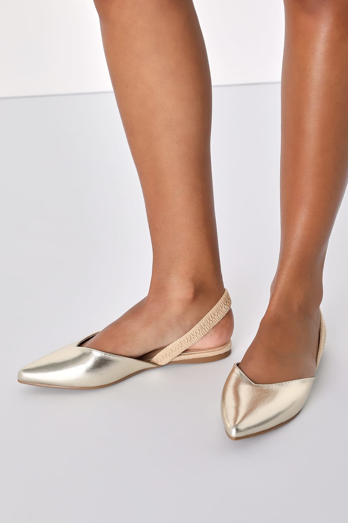 A pair of gold flats
