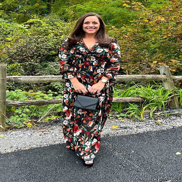 Reviewer wearing the dress with a black bag