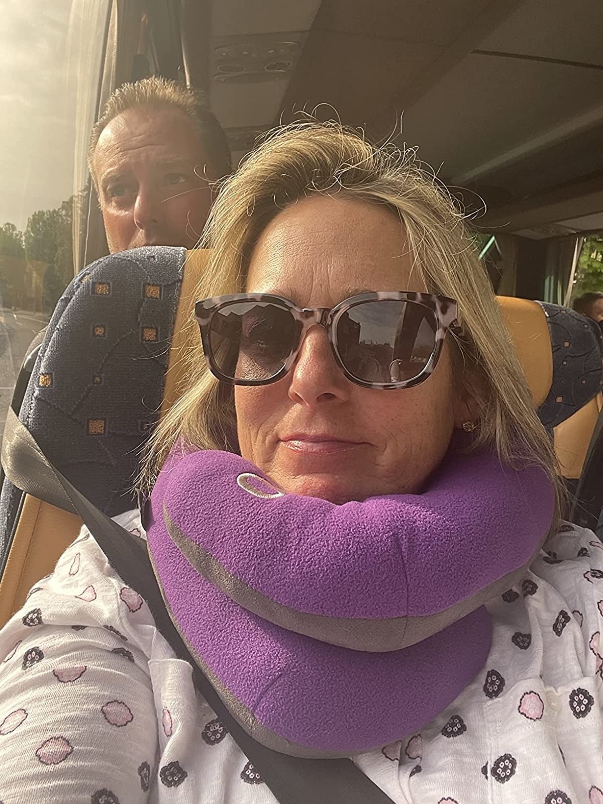 Reviewer wearing the purple neck pillow