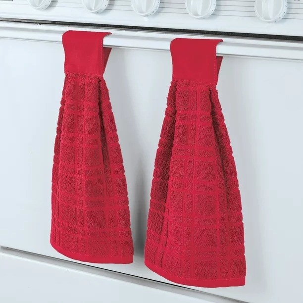 The red towels hanging off of the oven handle