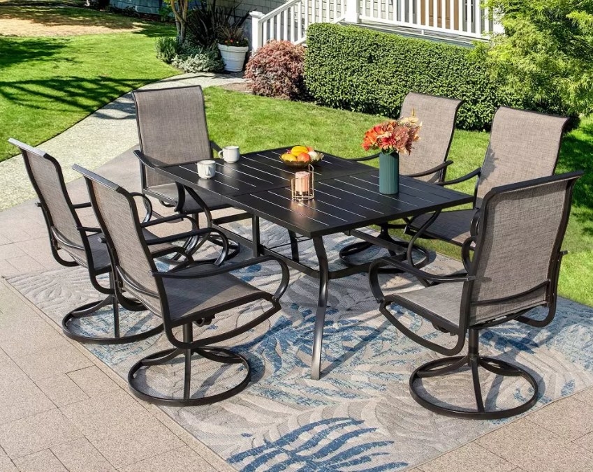 The dining set placed on top of an area rug in the garden