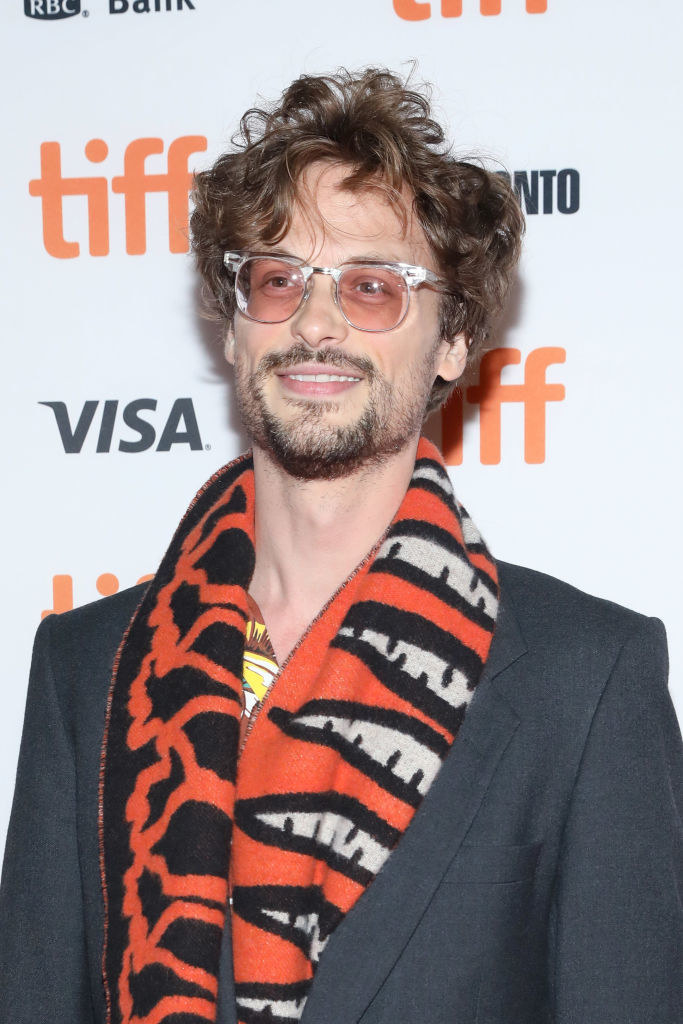 Matthew with a beard and mustache and bright scarf
