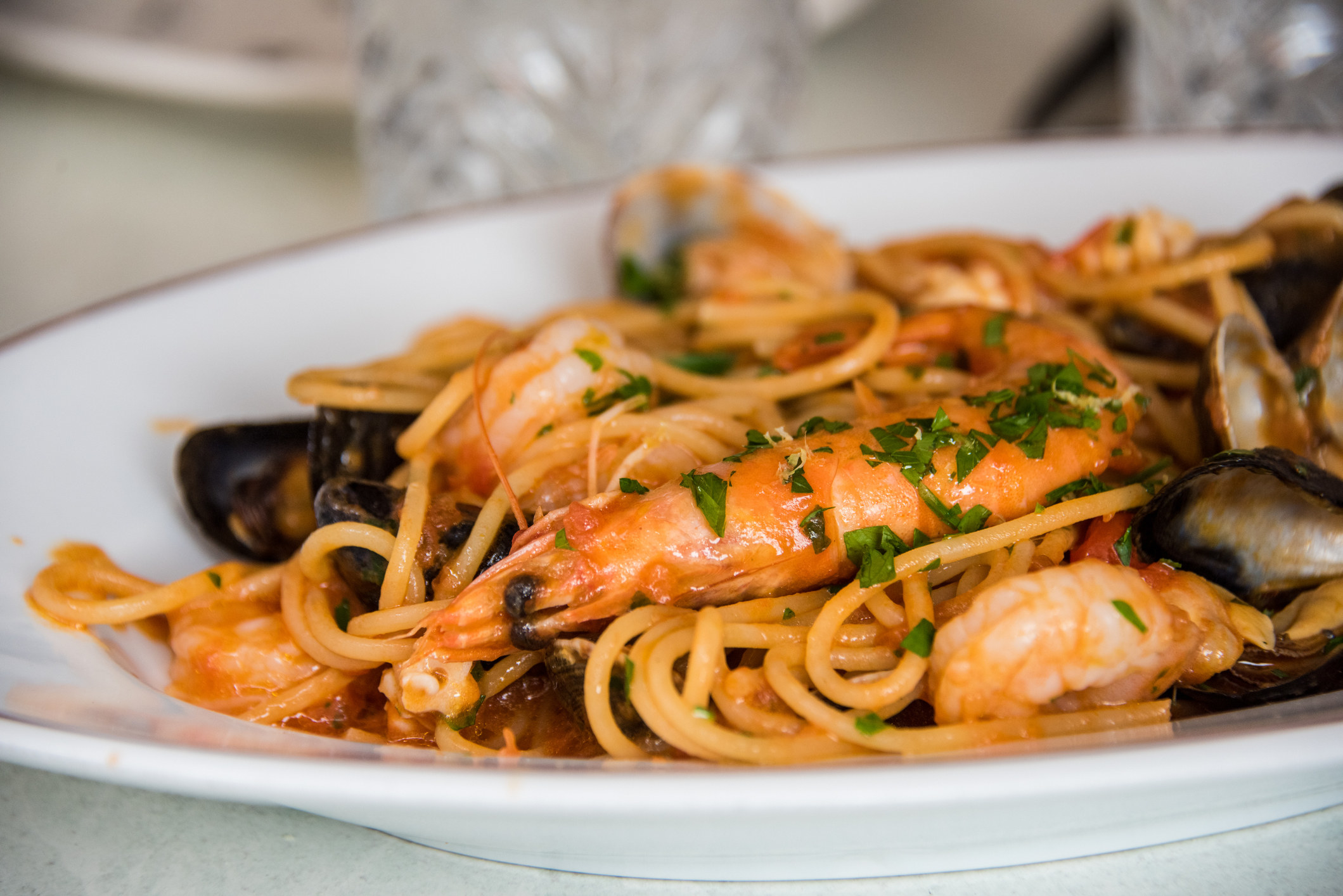 A plate of spaghetti with prawns, squid, clams, mussels