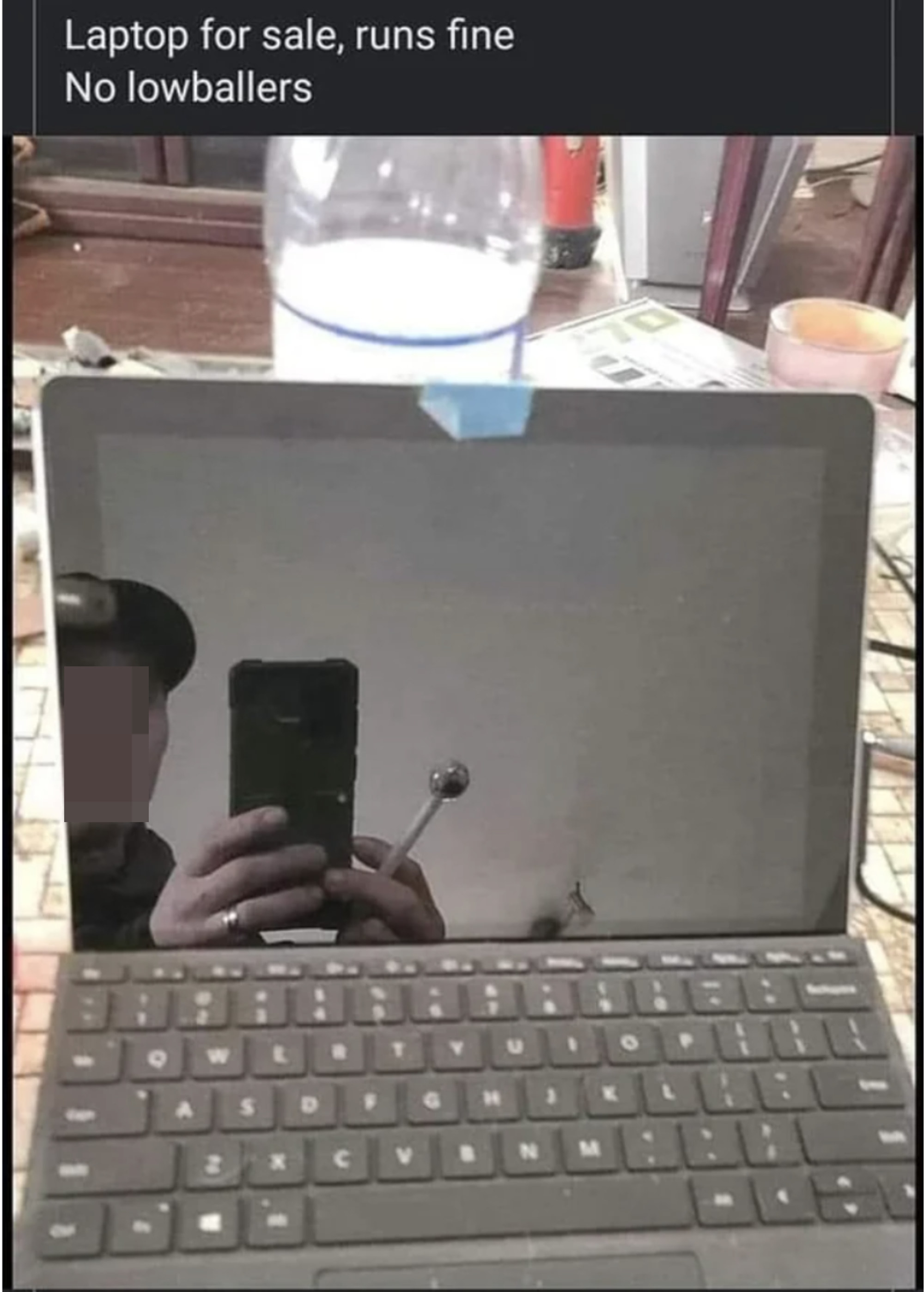 phone and crack pipe in the laptop reflection