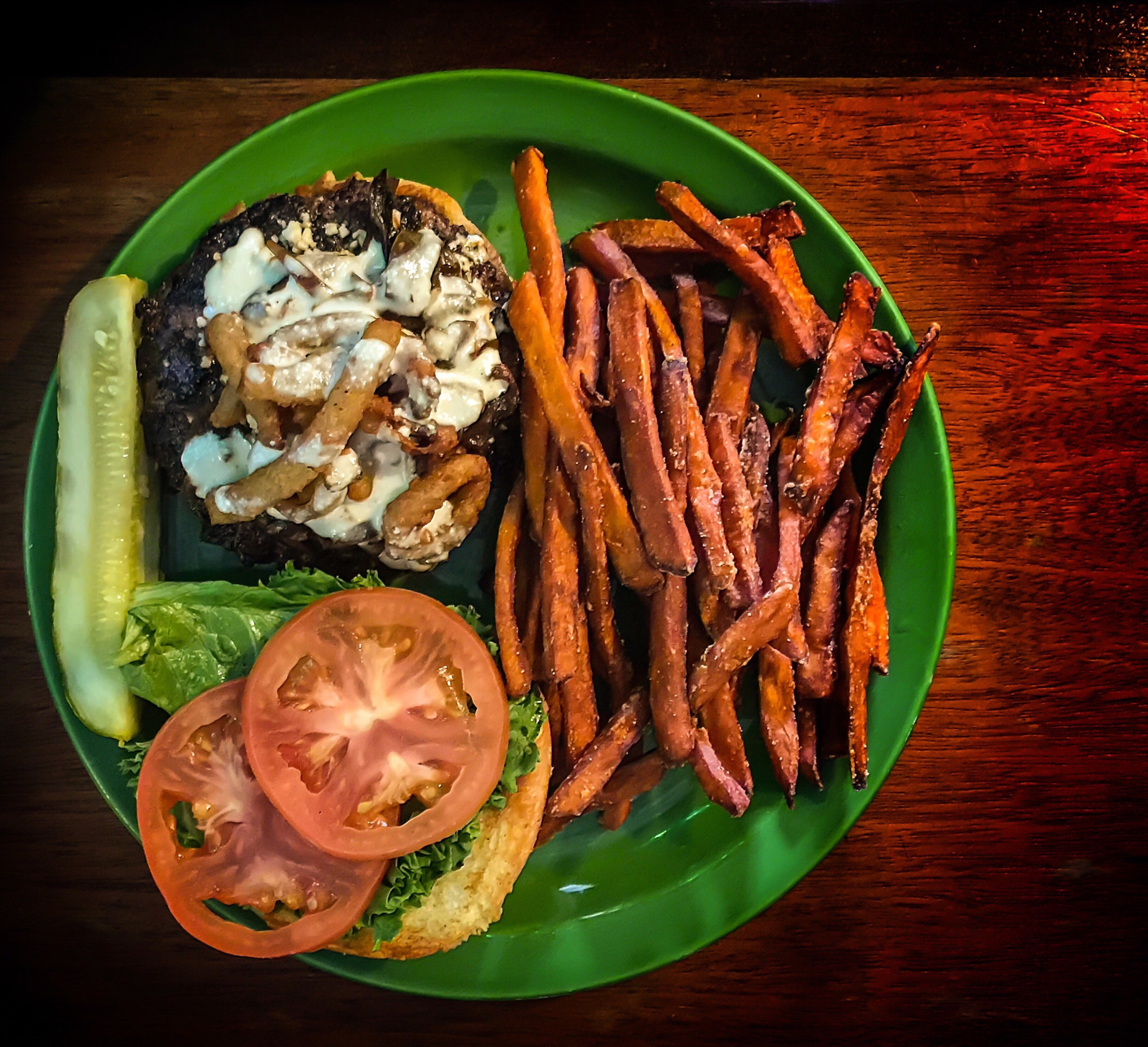 A burger with a side of sweet potato fries