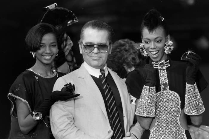 Karl Lagerfeld positing with models