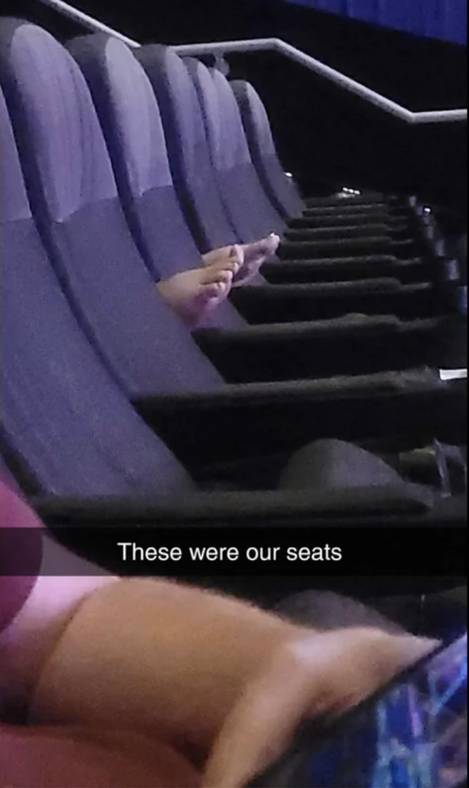 bare feet peeking out through the movie seats