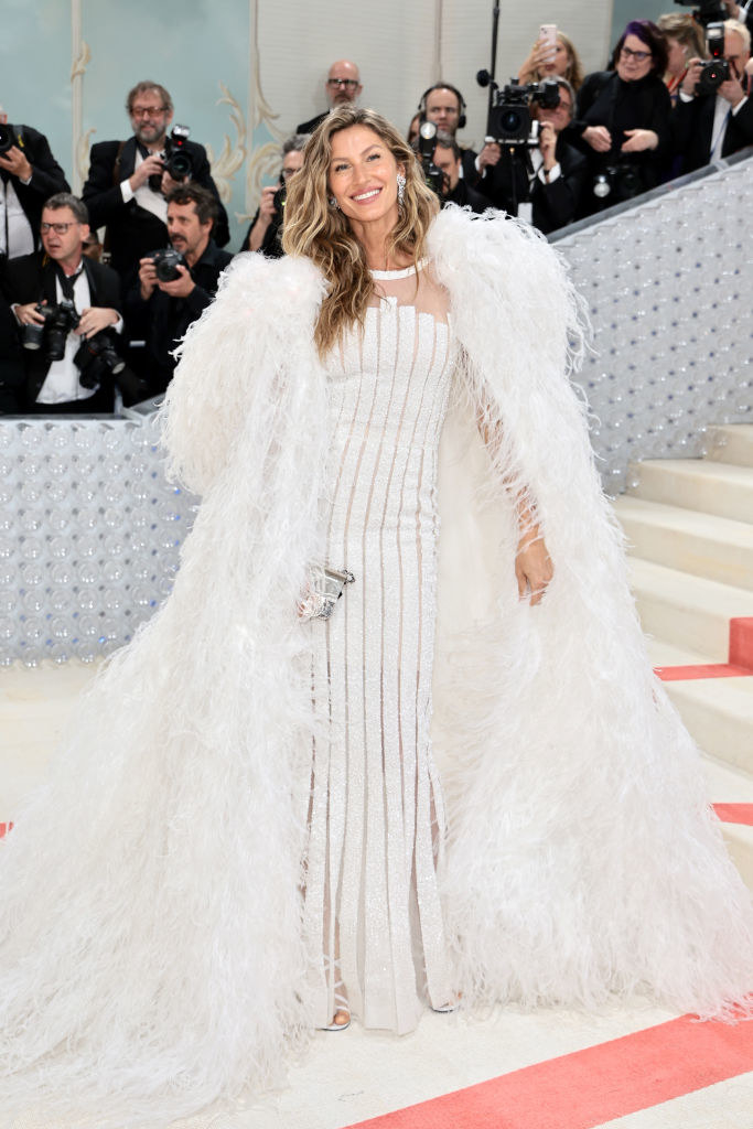 Gisele Bündchen attends The 2023 Met Gala in a white fur coat