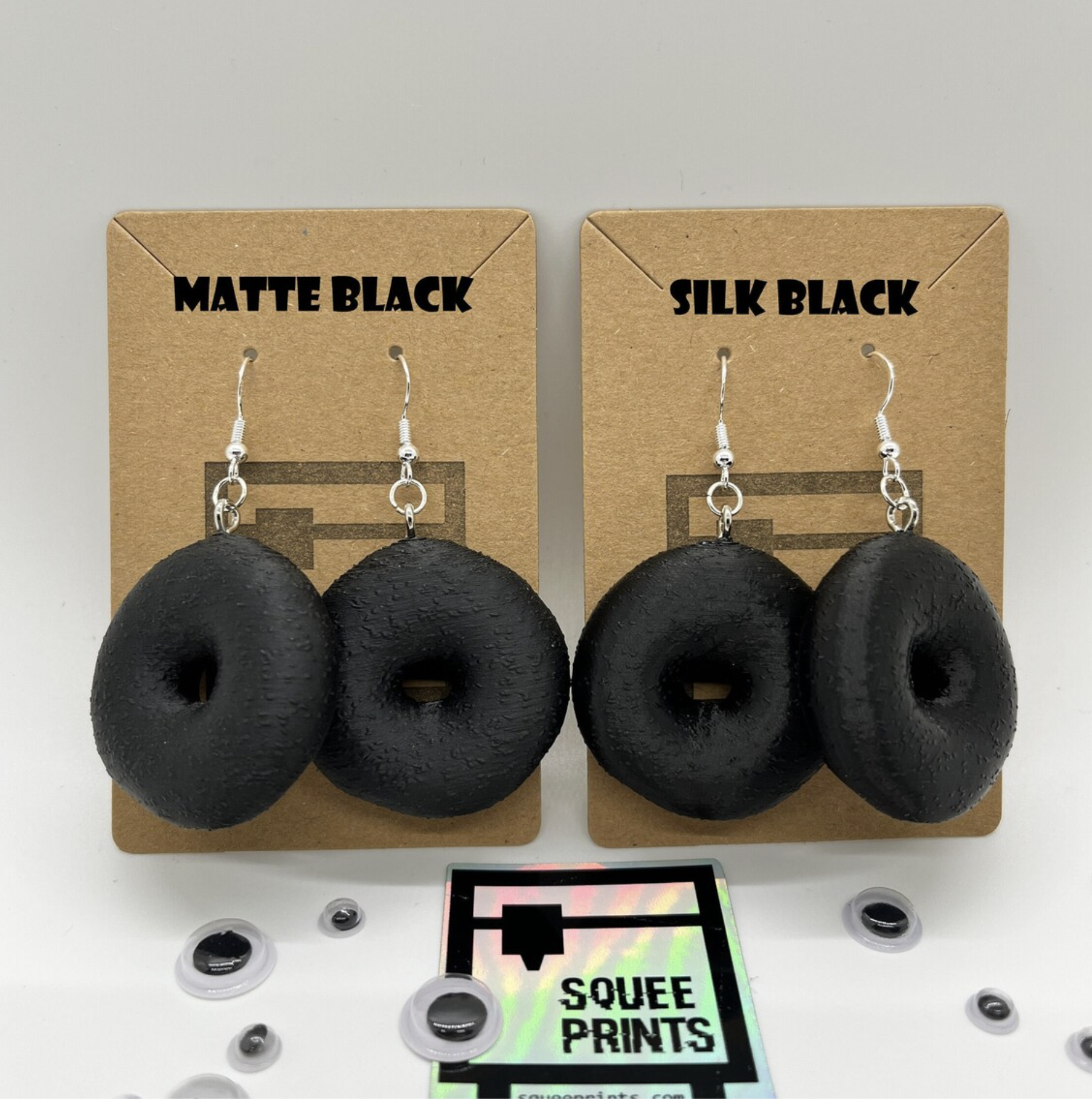 Two sets of Everything Bagel earrings on brown backing