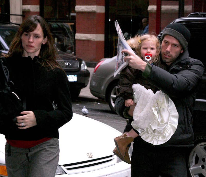 ben and jen walking with their baby