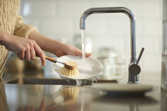 A person washing a dish