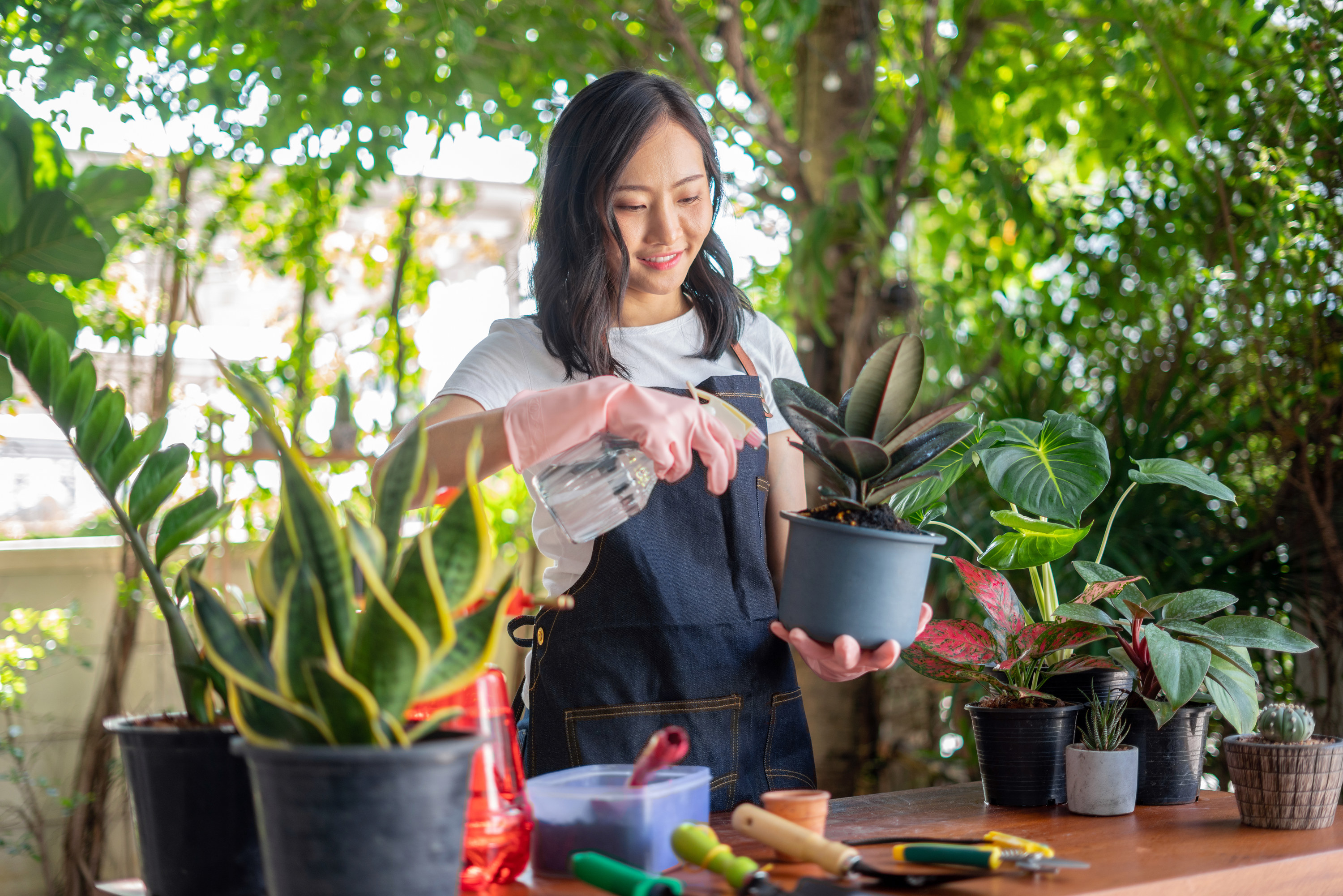 A smiling woman gardening