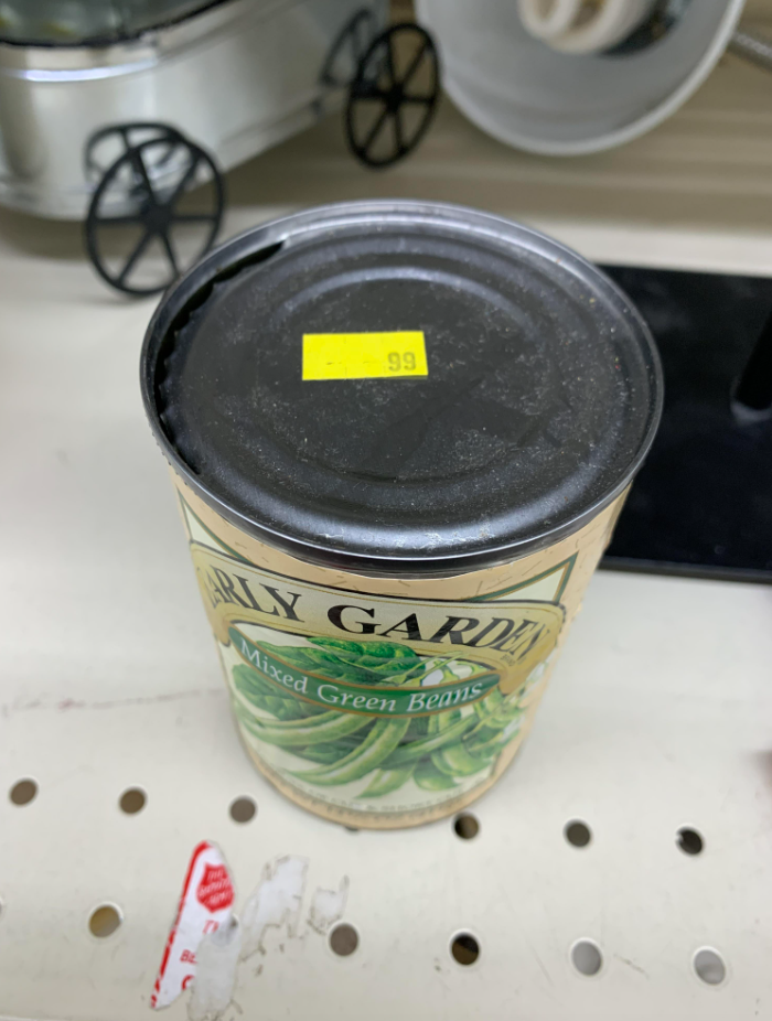 An opened can of green beans for sale