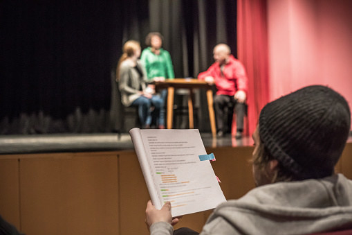 A high school student studying lines in theater
