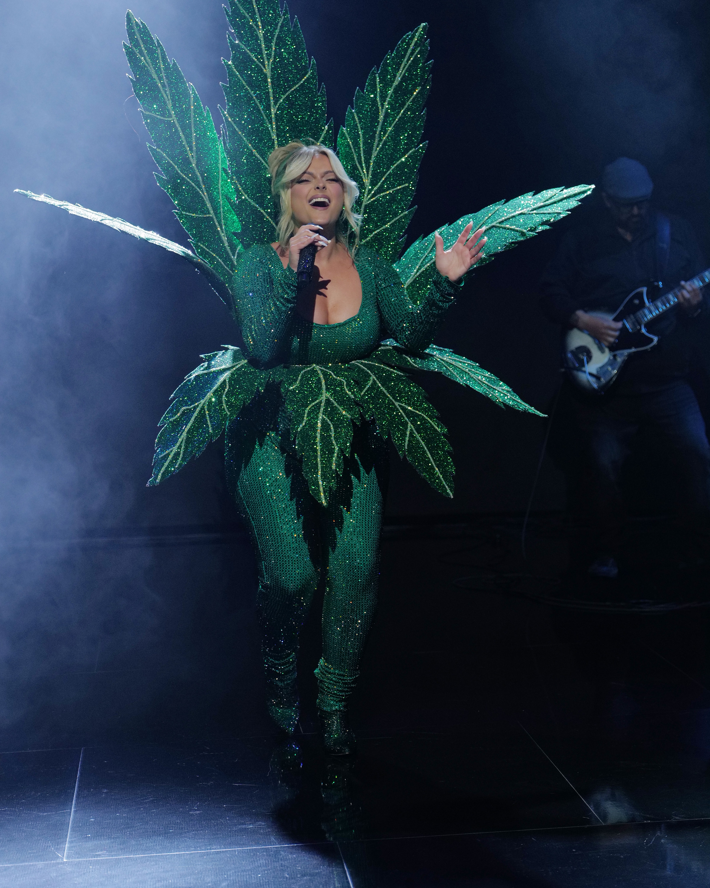 Bebe Rexha onstage in a leotard made to look like a leaf