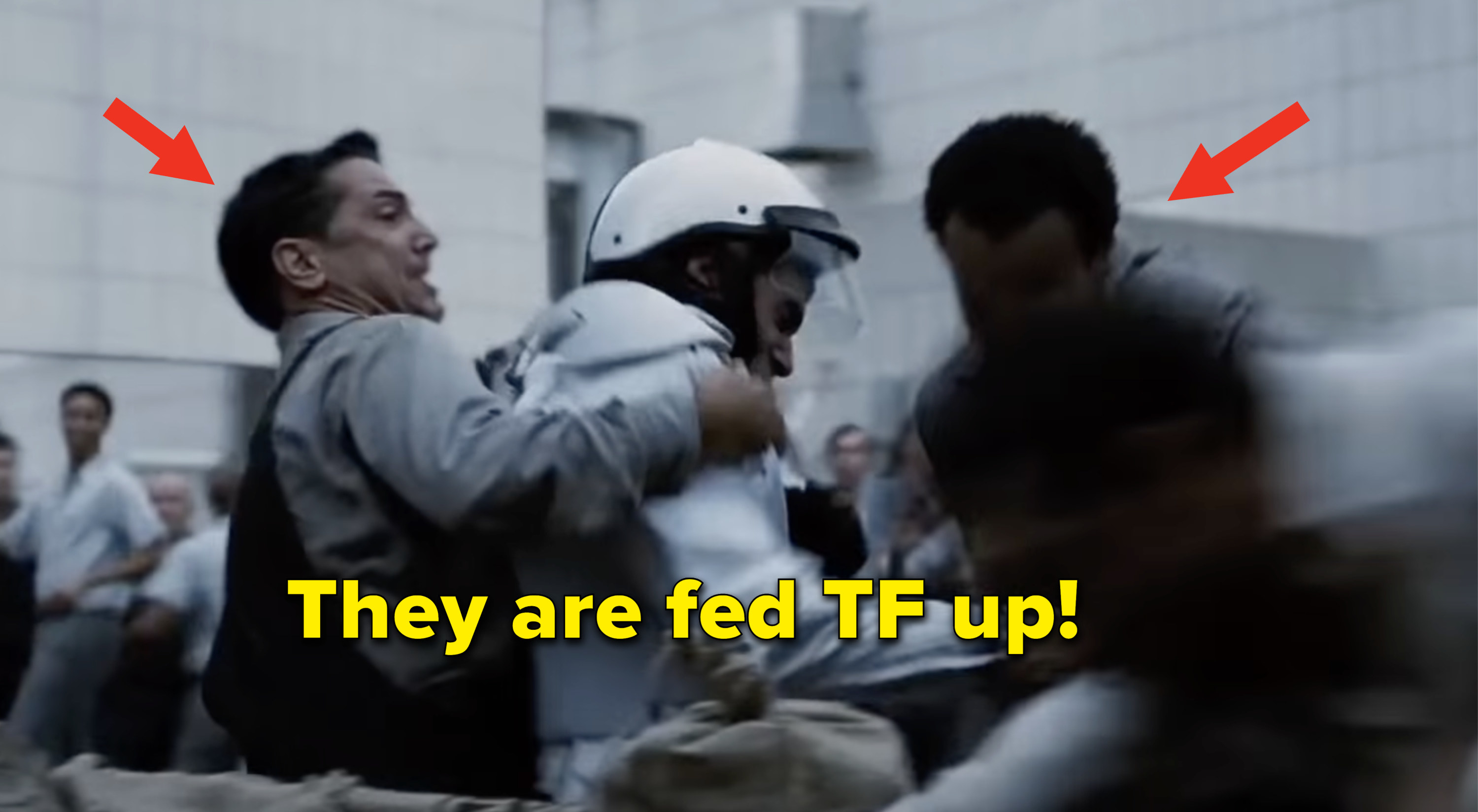 Two protestors fighting against a guard with the caption &quot;They are fed TF up!&quot;