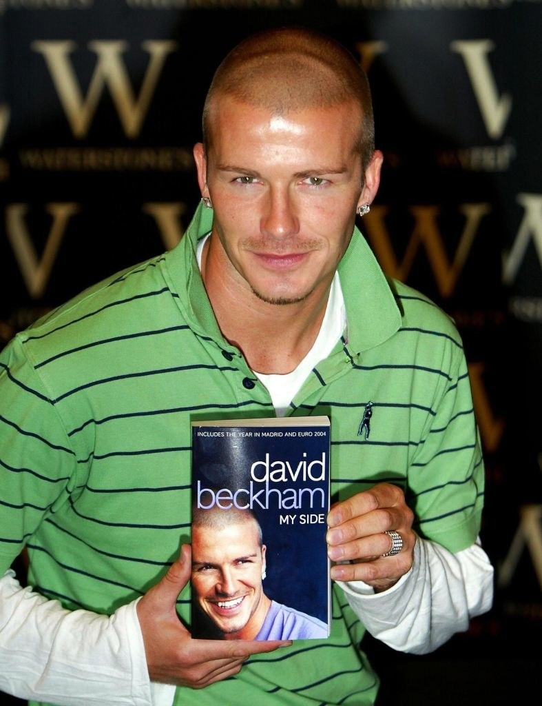 David Beckham holding his memoir