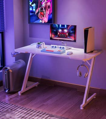 the white desk with gaming equipment on top