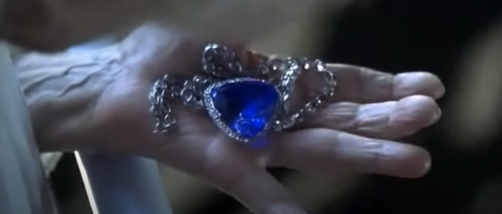 A woman holds a massive diamond necklace