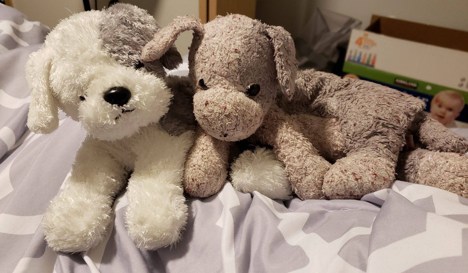 Two stuffed toys on a bed