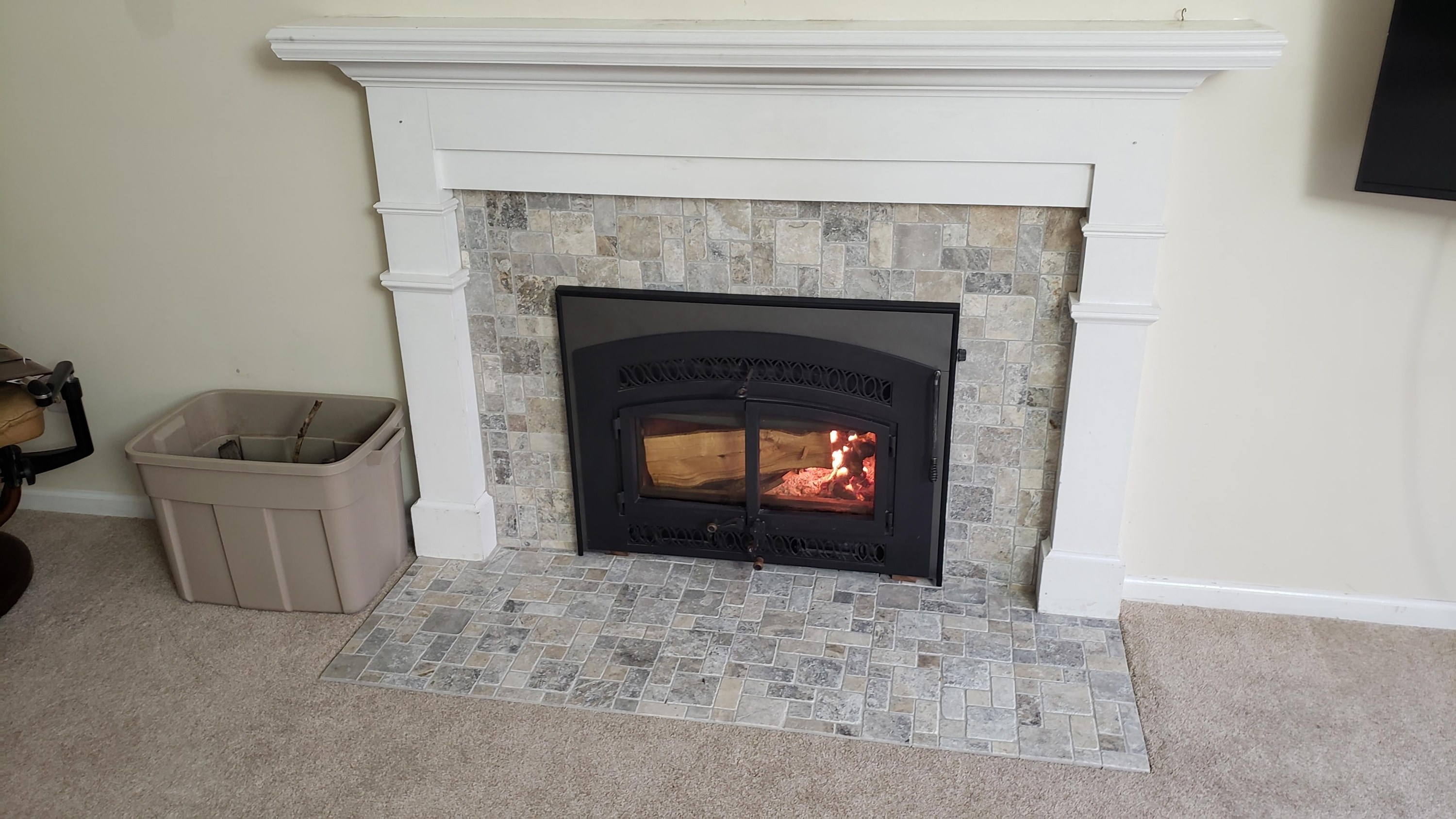 refurbished fireplace with fresh white paint and new tile surround
