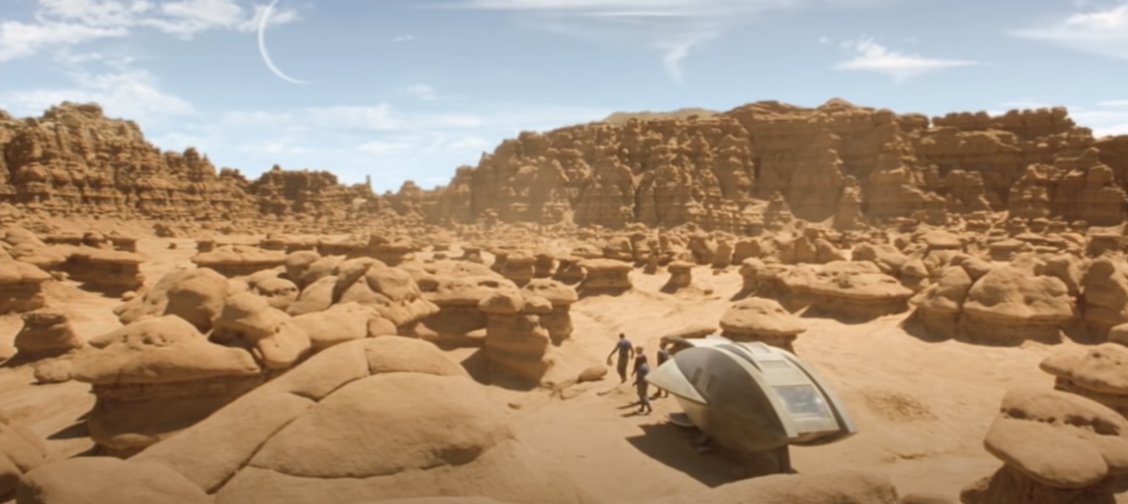 A spaceship lands on a desert planet