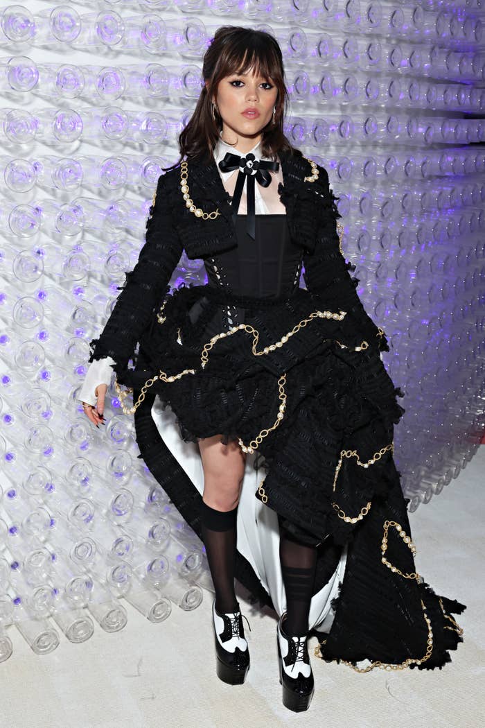 Closeup of Jenna Ortega at the Met Gala in an intricate corset dress with an asymmetrical skirt