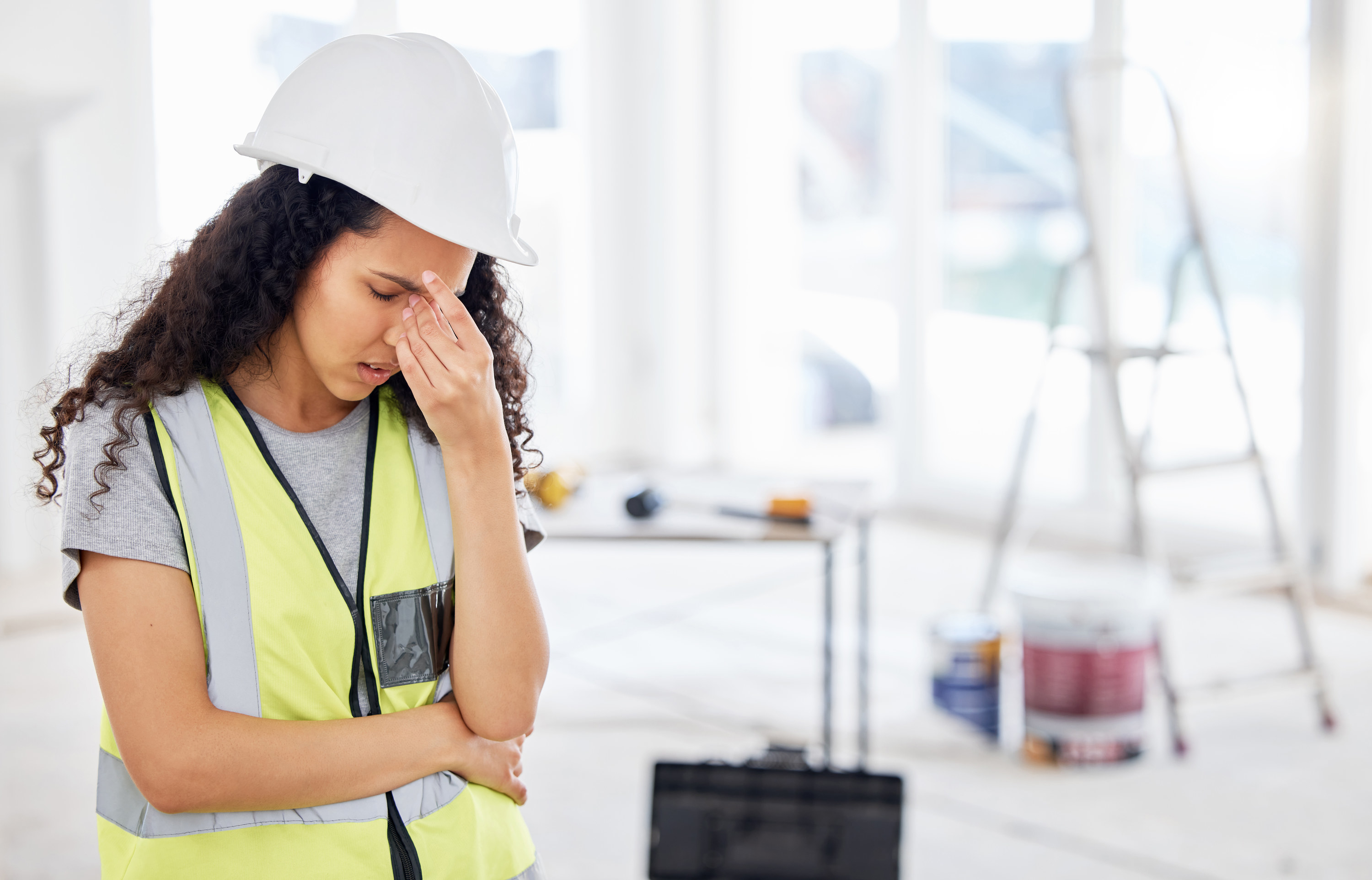 Stressed-out woman doing home repairs