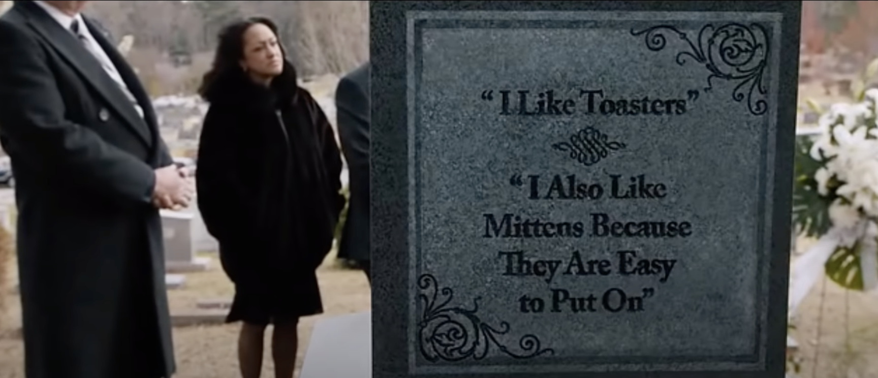 A tombstone reading &quot;I like toasters. I also like mittens because they&#x27;re easy to put on&quot;