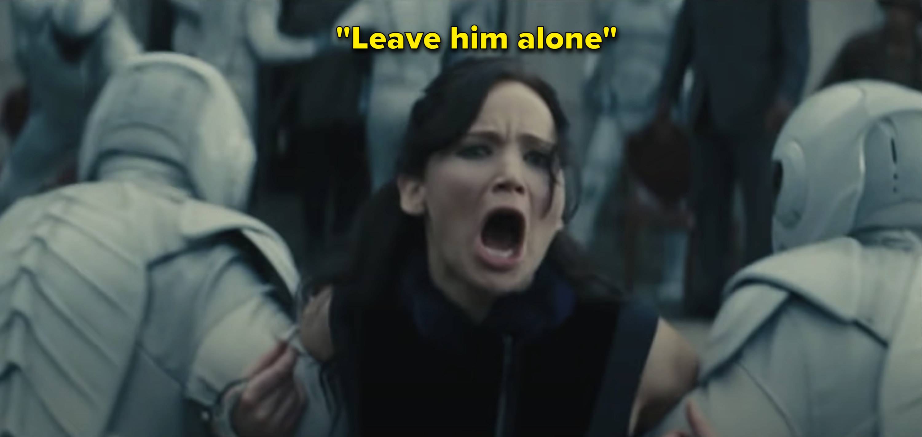 Katniss from &quot;The Hunger Games: Catching Fire&quot; movie screaming while being dragged away by guards with the caption &quot;Leave him alone&quot;
