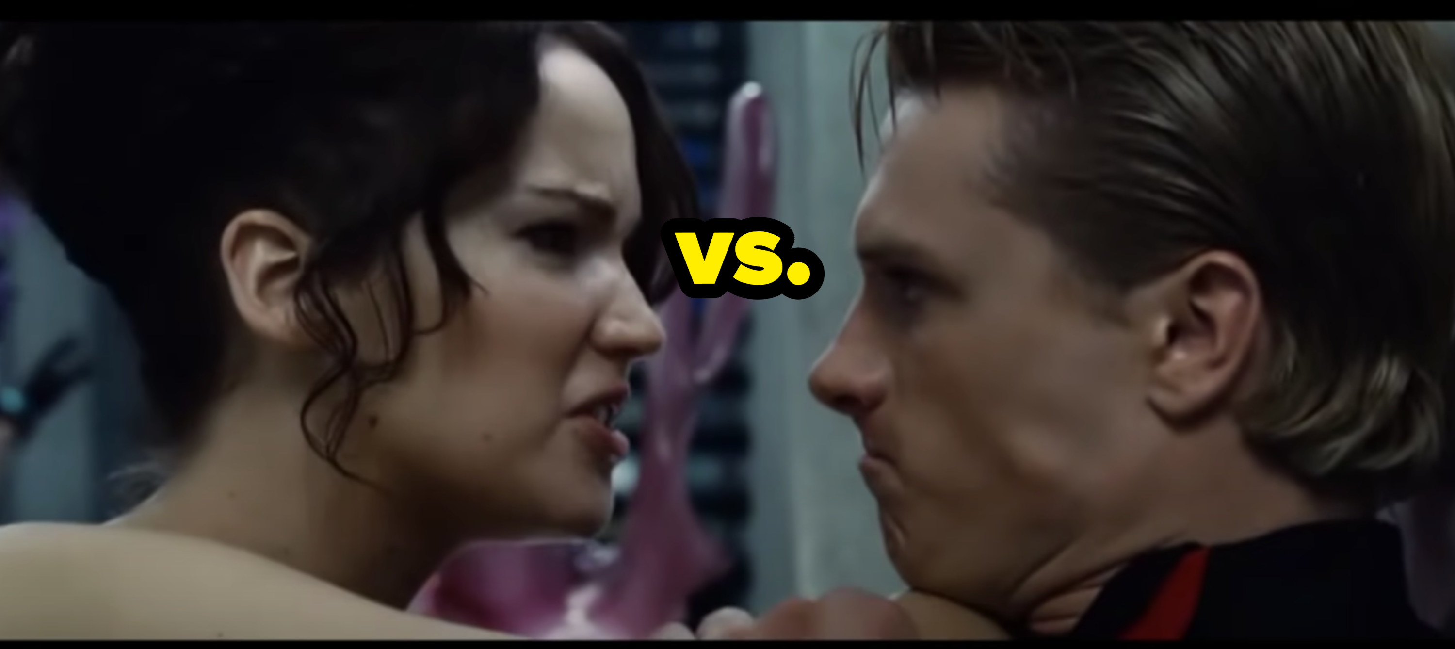 Katniss angrily pushing Peeta up against the wall with her elbow in his neck with the caption &quot;vs.&quot;