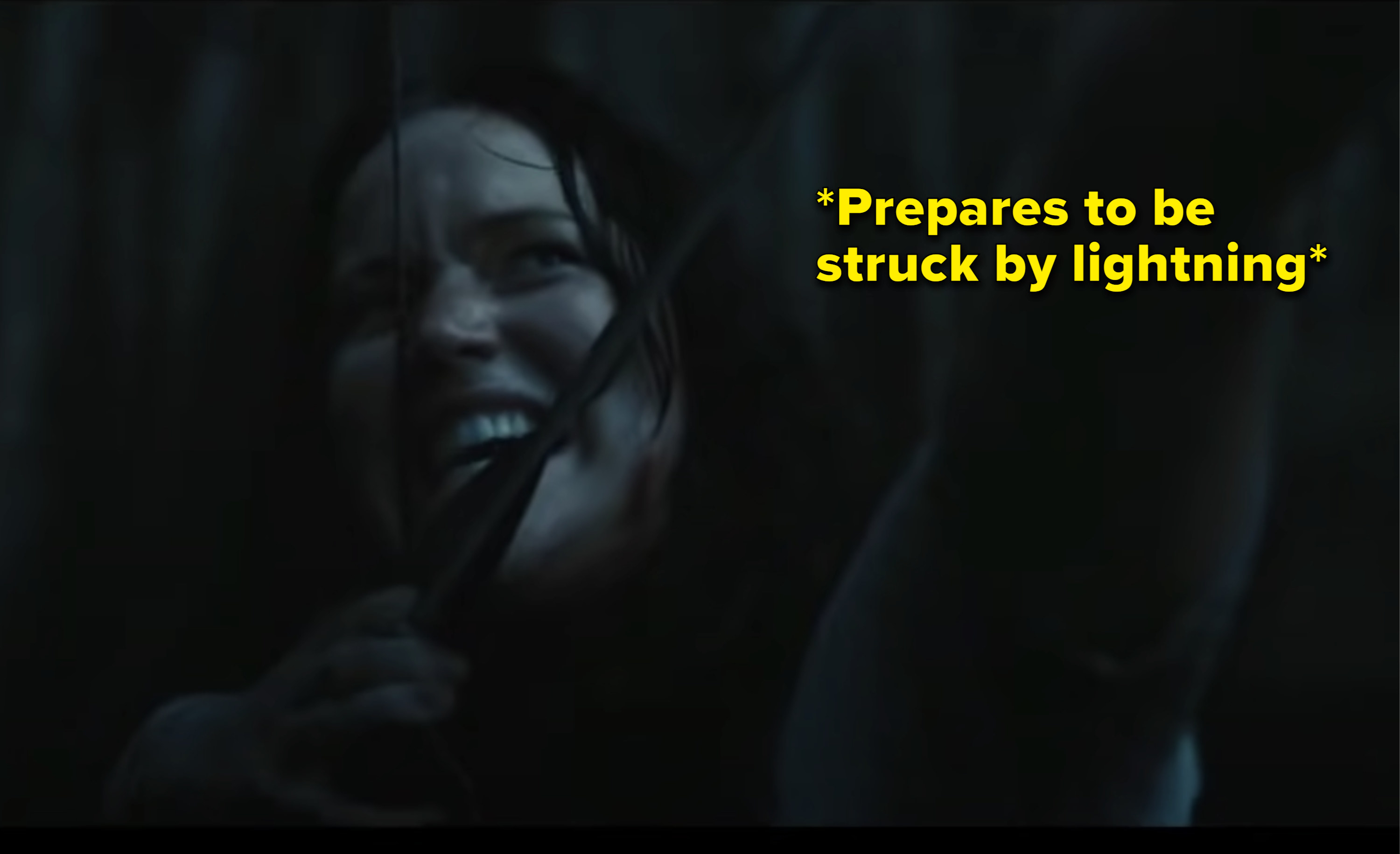 Katniss pulling her arrow back with the caption &quot;prepares to be struck by lightning&quot;